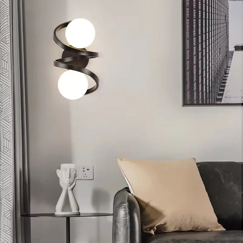 Moderne Wandleuchte mit spiralförmigem Rahmen und mattierter Glaskugel
