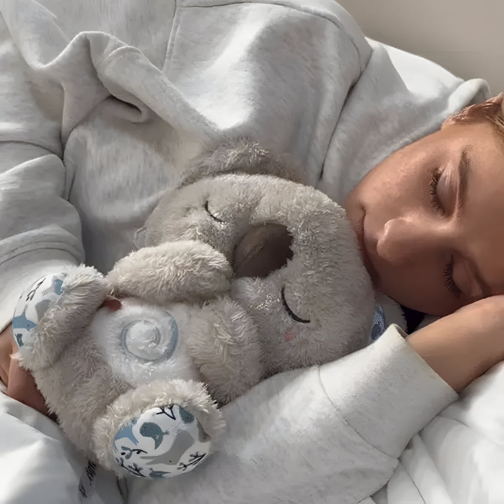 Set mit rhythmisch atmendem Leucht-Plüschbären als Schlafspielzeug für Babys